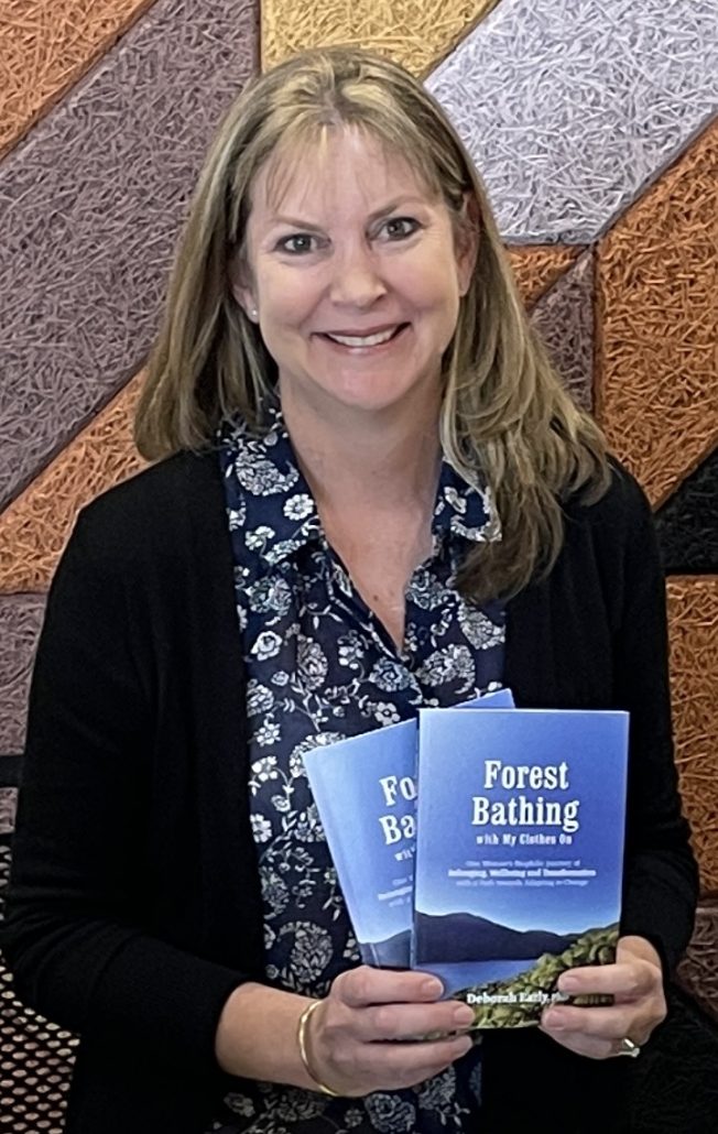 Dr Deborah Early posing with book Forest Bathing Dr Deborah Early posing with book Forest Bathing